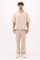 Front view of beige linen shirt with button-up style
